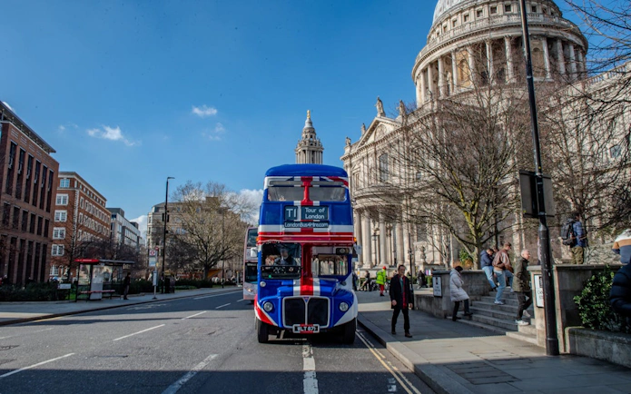 Double-decker bus near St. Paul's Cathedral, Central London, for afternoon tea tour.