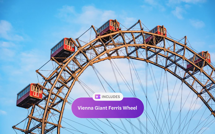 Historic Ferris wheel with red carriages at Vienna Prater Park against blue sky.