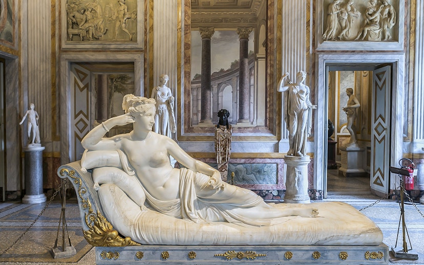 Borghese Gallery sculpture room with reclining marble statue and classical decor.