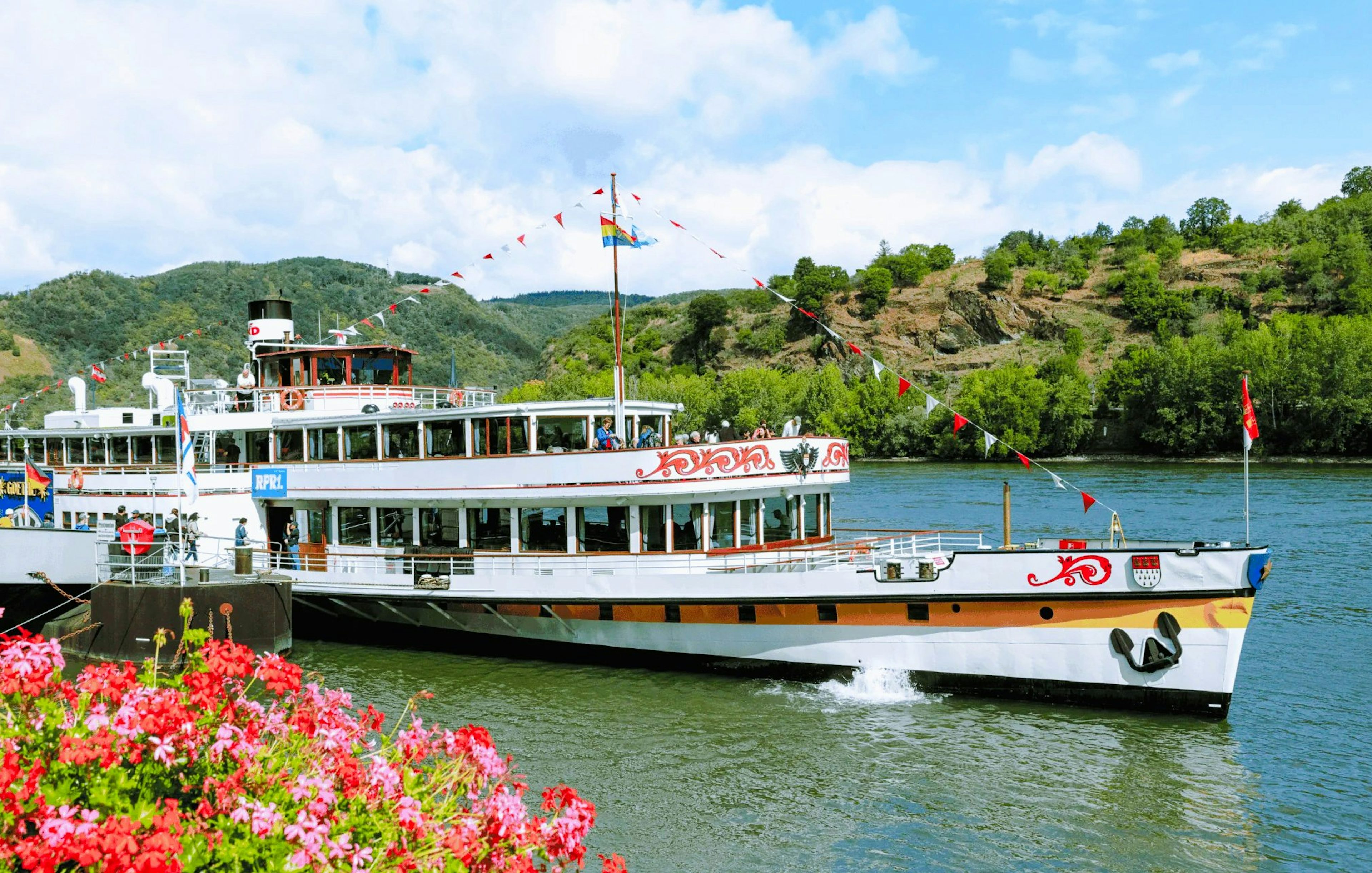 Paddle steamer Goethe cruising past Pfalzgrafenstein Castle on the Rhine River, Germany.