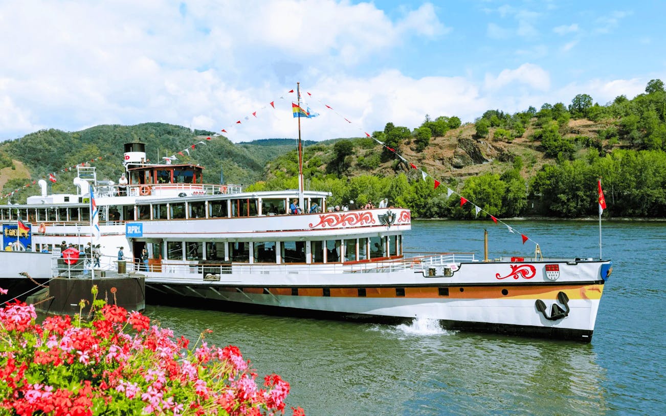 Paddle steamer Goethe cruising past Pfalzgrafenstein Castle on the Rhine River, Germany.