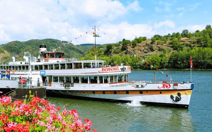 Paddle steamer Goethe cruising past Pfalzgrafenstein Castle on the Rhine River, Germany.