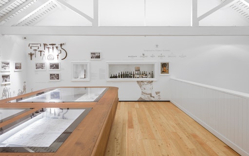 Graham's Port Lodge exhibit with vintage wine bottles and historical photos.