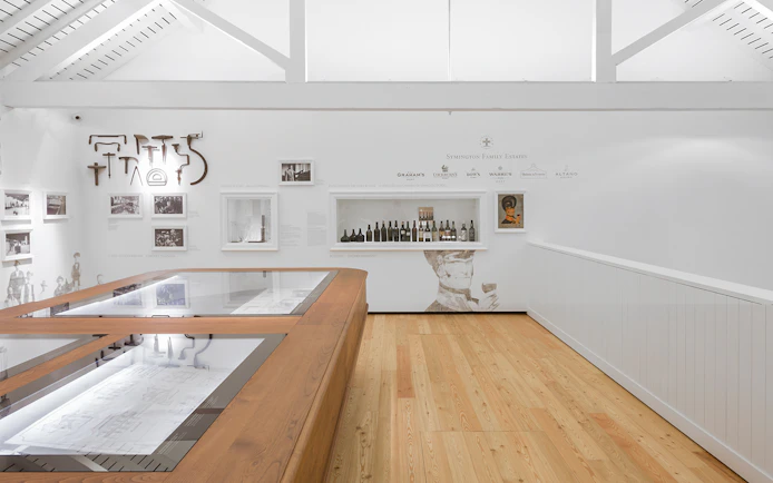 Graham's Port Lodge exhibit with vintage wine bottles and historical photos.