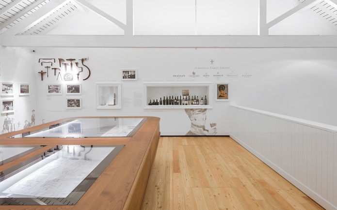 Graham's Port Lodge exhibit with vintage wine bottles and historical photos.