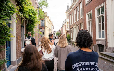 Small group walking through historic Utrecht street with local guide.