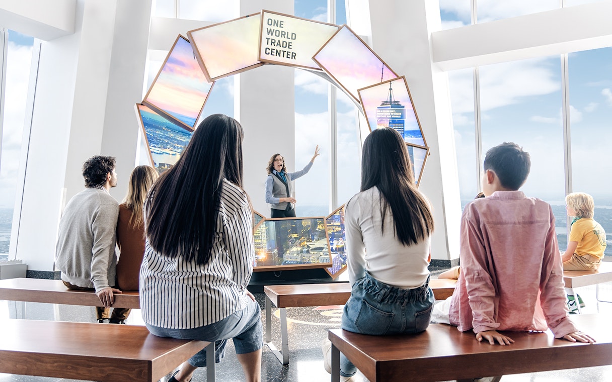 Visitors listening to a guide at One World Observatory, New York City.