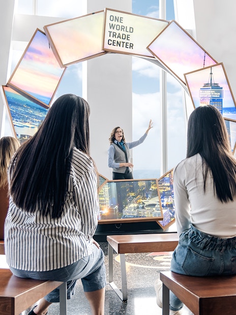 Visitors listening to a guide at One World Observatory, New York City.