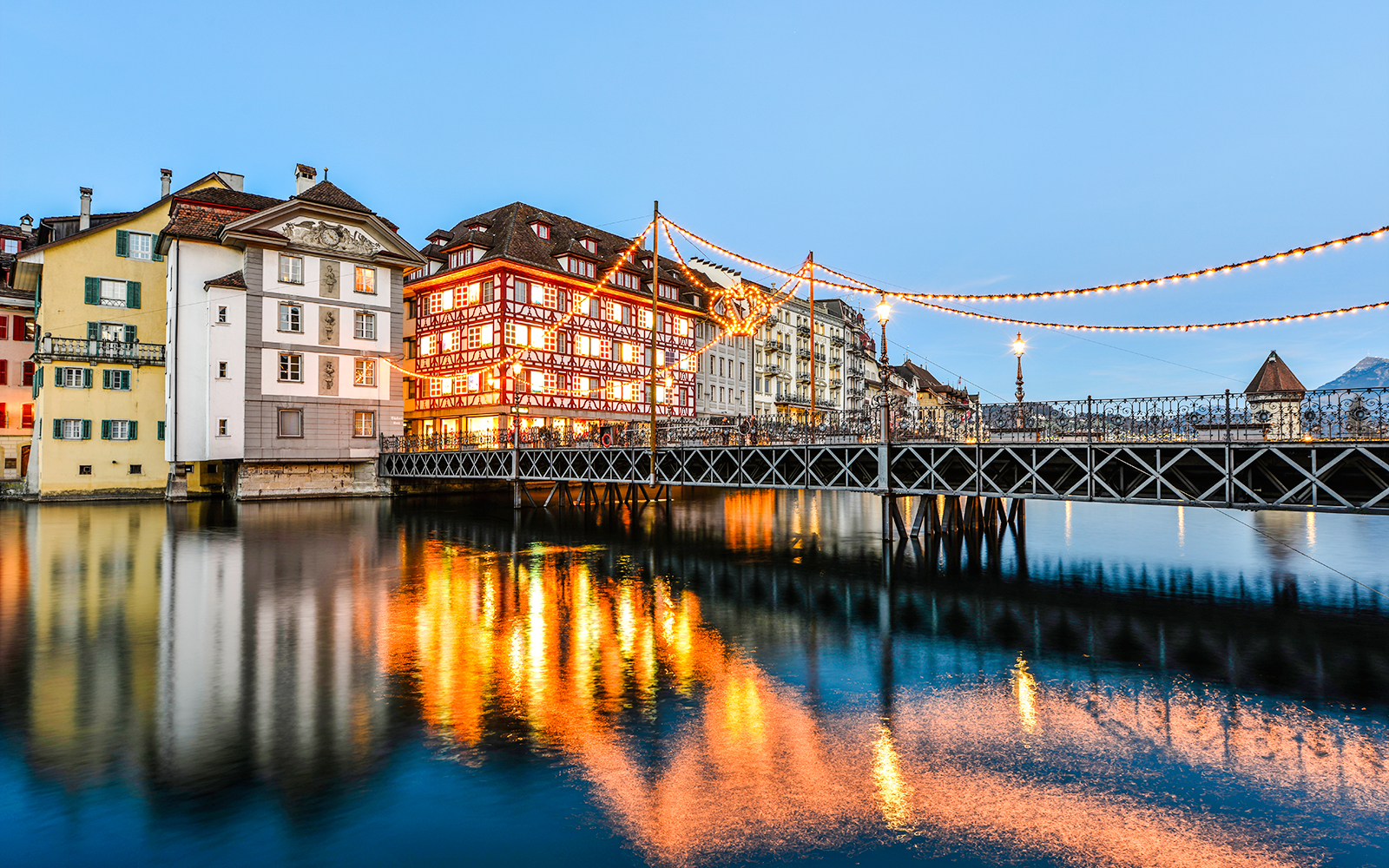 Luzern bridge with Christmas lights reflecting in the water.