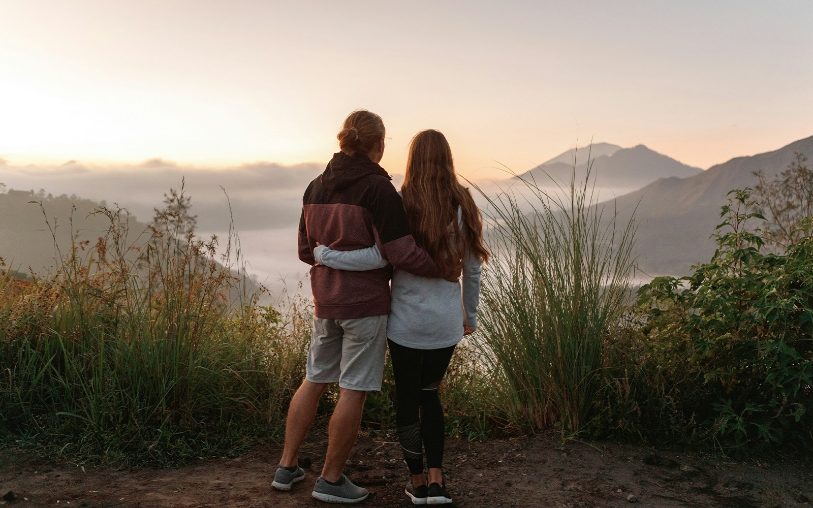 Couple looking at Mount Batur on a sunrise trek