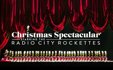 Radio City Rockettes in toy soldier costumes during Christmas Spectacular performance.