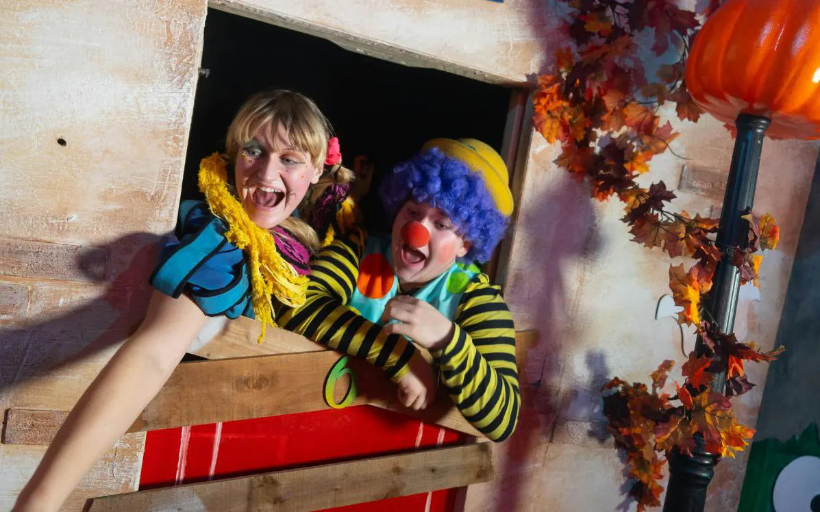 Clowns in colorful costumes at Alton Towers Scarefest attraction.