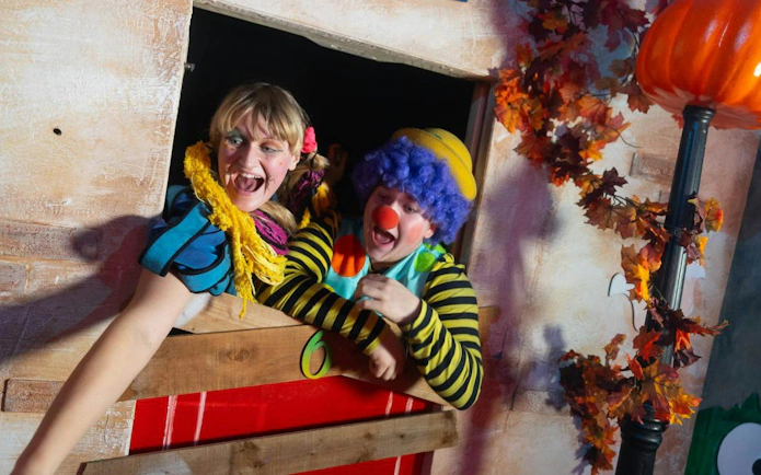 Clowns in colorful costumes at Alton Towers Scarefest attraction.