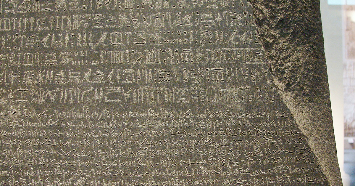 Rosetta Stone inscriptions at the British Museum, London, featuring ancient scripts.
