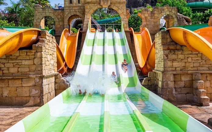 Visitors enjoying water slides at Aqualand Maspalomas in Adventurland.