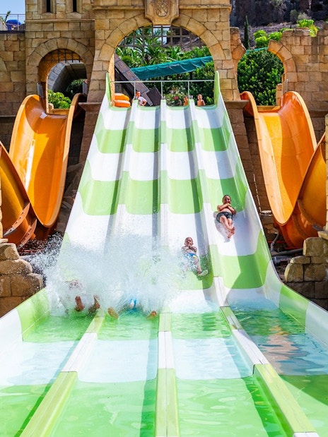 Visitors enjoying water slides at Aqualand Maspalomas in Adventurland.