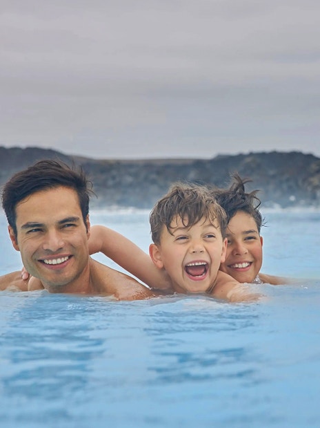 Family enjoying the geothermal waters of Blue Lagoon, Iceland.