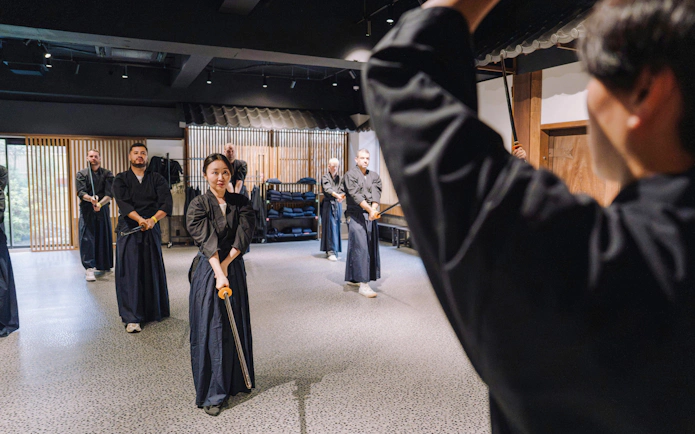 Participants practicing sword techniques at Samurai Museum Tokyo in Shinjuku.