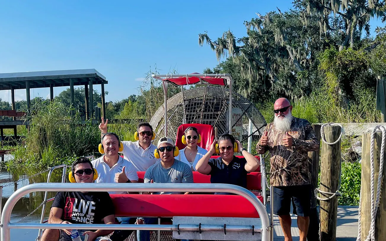 Group on airboat ready for swamp adventure tour in New Orleans.
