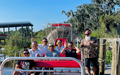 Group on airboat ready for swamp adventure tour in New Orleans.