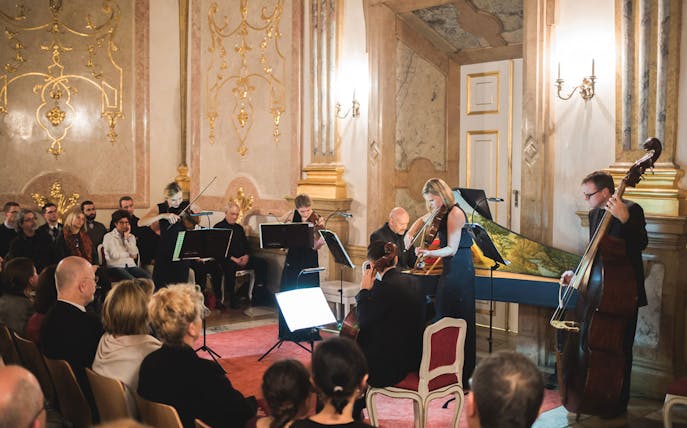Musicians performing classical music at Mirabell Palace concert hall, Salzburg.