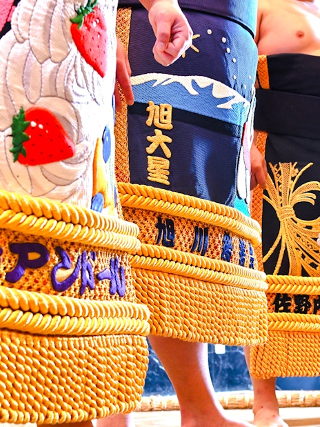 Sumo wrestlers in traditional attire at Asakusa Sumo Club, Tokyo.