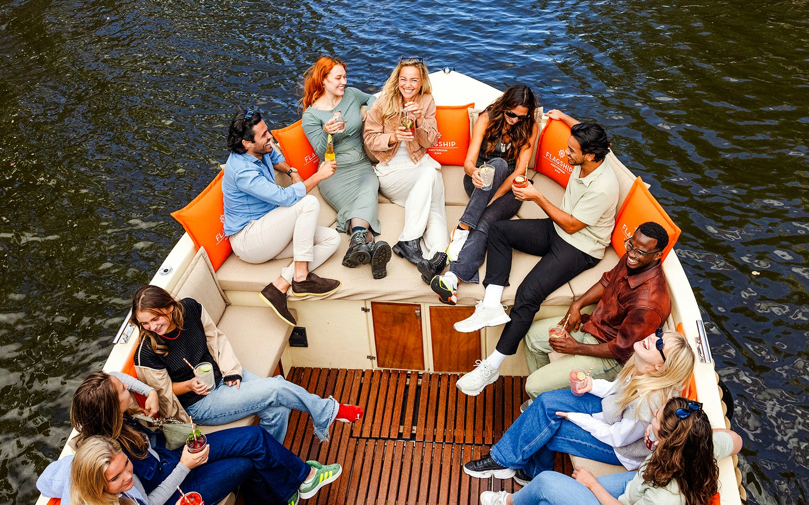 Guests enjoying a scenic view on a luxury open boat cruise along Amsterdam's historic canals.