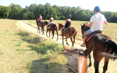 Horseback riders on a trail in Chianti countryside, Tuscany.
