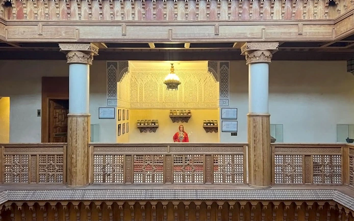 Interior view of Moroccan Culinary Arts Museum with intricate woodwork and traditional decor.