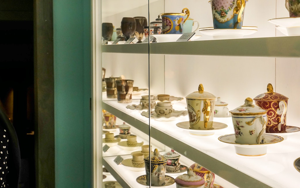 Antique chocolate cups displayed at Choco Story Brussels museum exhibit.