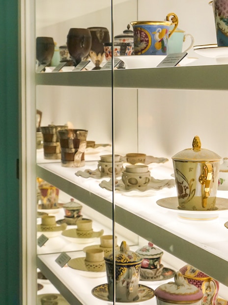 Antique chocolate cups displayed at Choco Story Brussels museum exhibit.