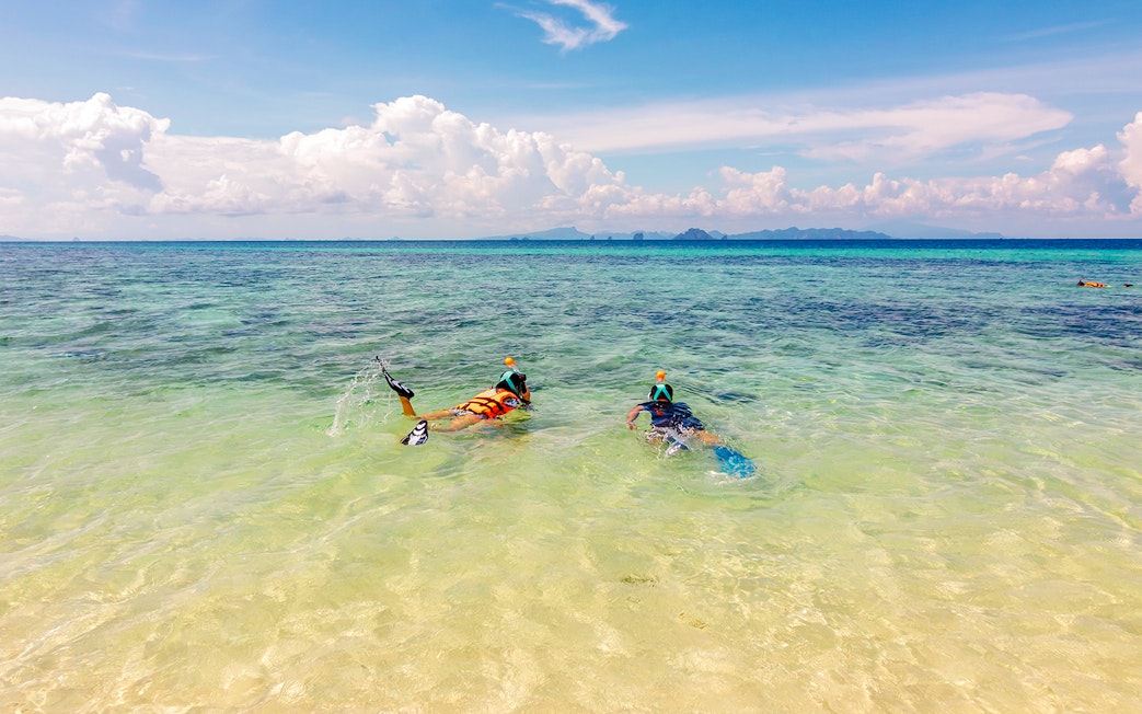 Snorkelers exploring clear waters near Bamboo Island, Thailand.