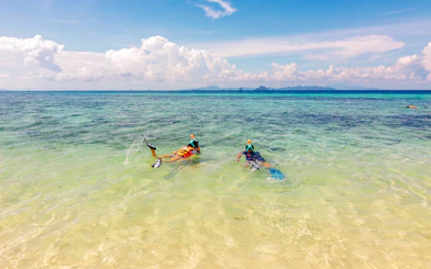 Snorkelers exploring clear waters near Bamboo Island, Thailand.