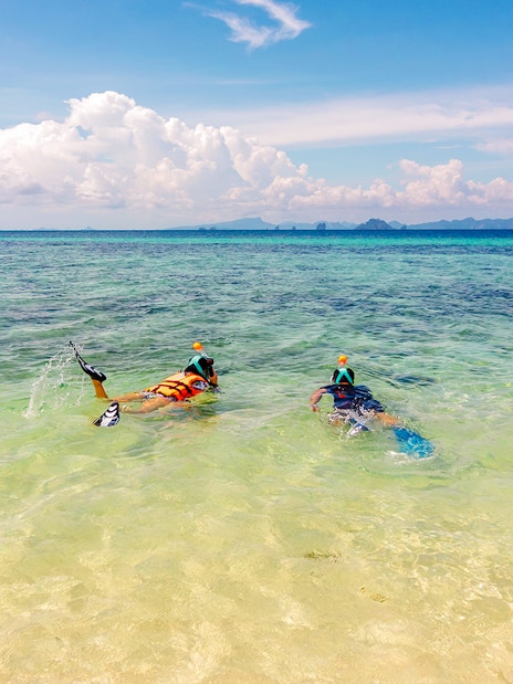 Snorkelers exploring clear waters near Bamboo Island, Thailand.