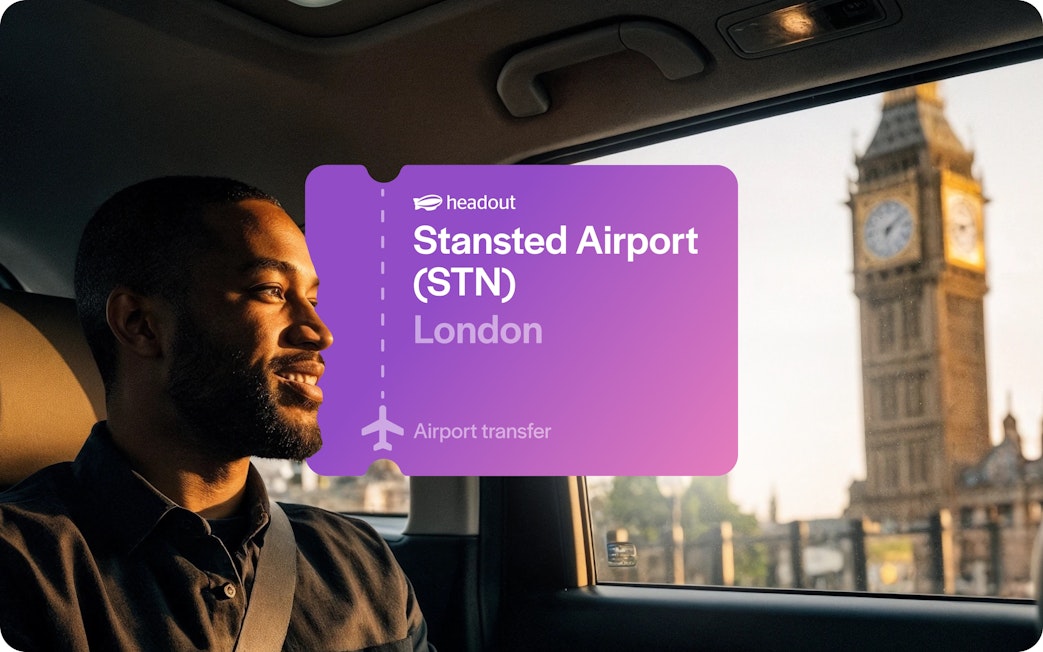 Man in car with Big Ben visible through window, London airport transfer.