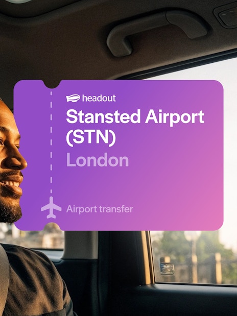 Man in car with Big Ben visible through window, London airport transfer.