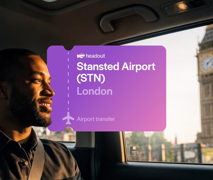 Man in car with Big Ben visible through window, London airport transfer.
