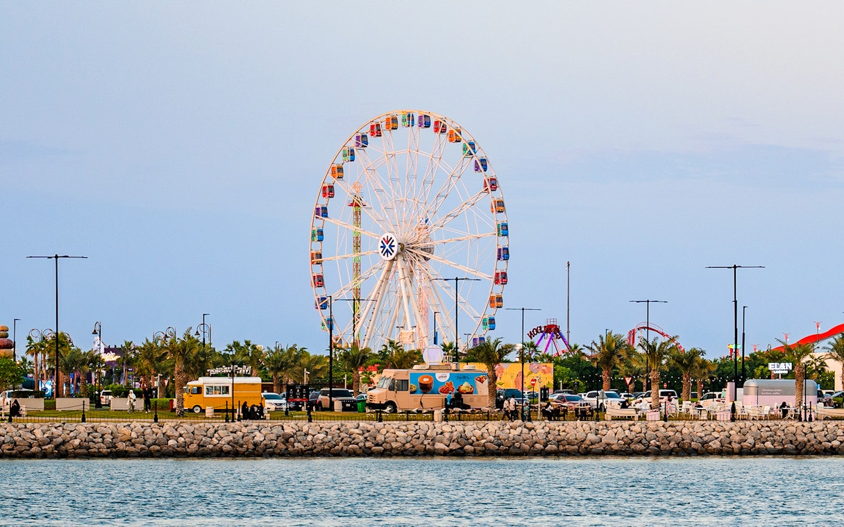Ferris wheel and food trucks at Lusail Winter Wonderland, Qatar.