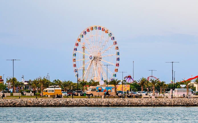 Ferris wheel and food trucks at Lusail Winter Wonderland, Qatar.