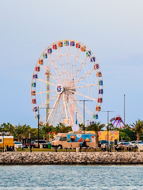 Ferris wheel and food trucks at Lusail Winter Wonderland, Qatar.