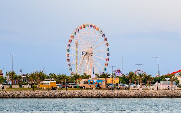 Ferris wheel and food trucks at Lusail Winter Wonderland, Qatar.