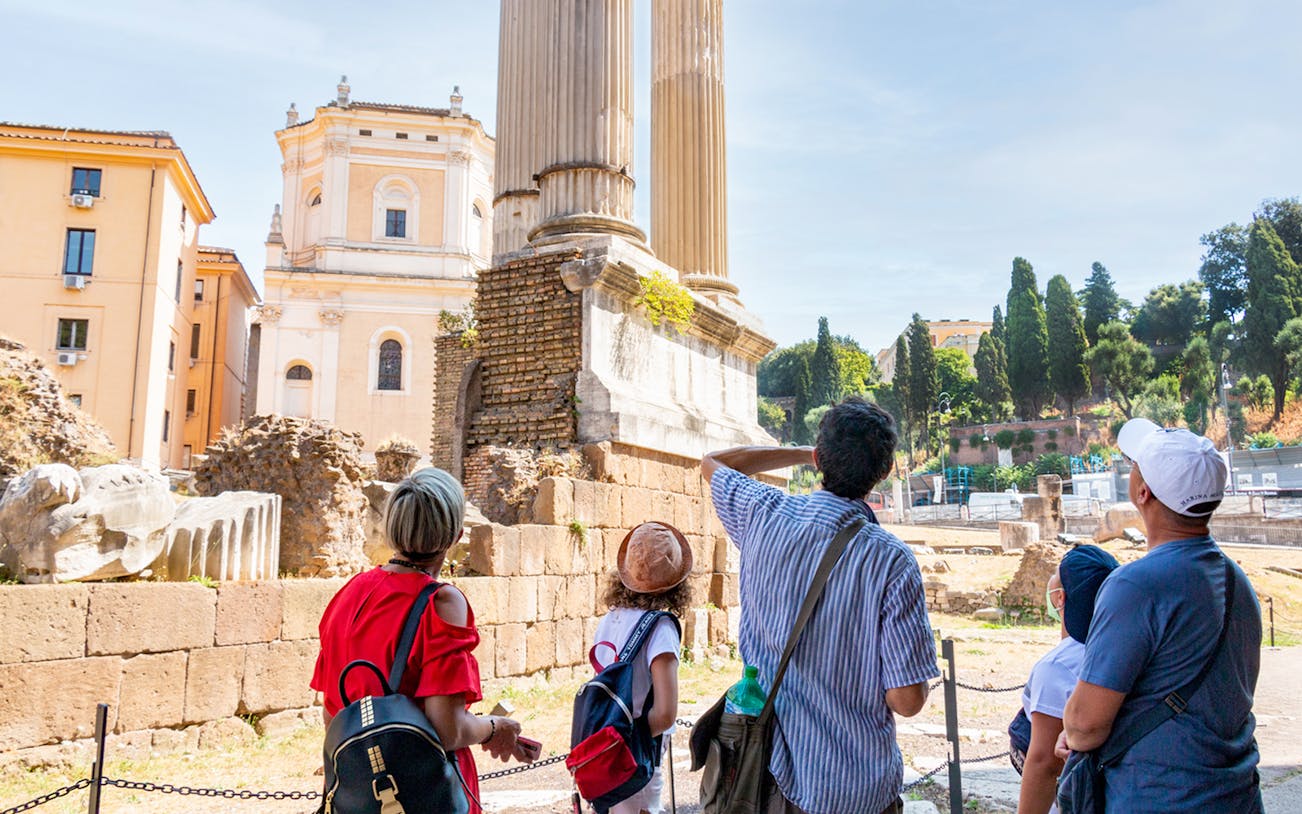 Tourists exploring ancient ruins in Rome's Jewish Ghetto.