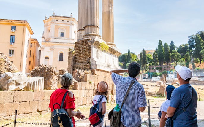Tourists exploring ancient ruins in Rome's Jewish Ghetto.