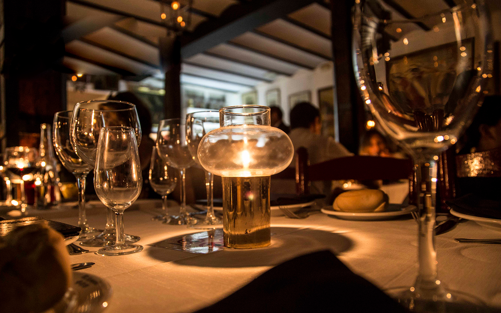 Candlelit table setting at Tablao El Arenal during a flamenco show in Seville.
