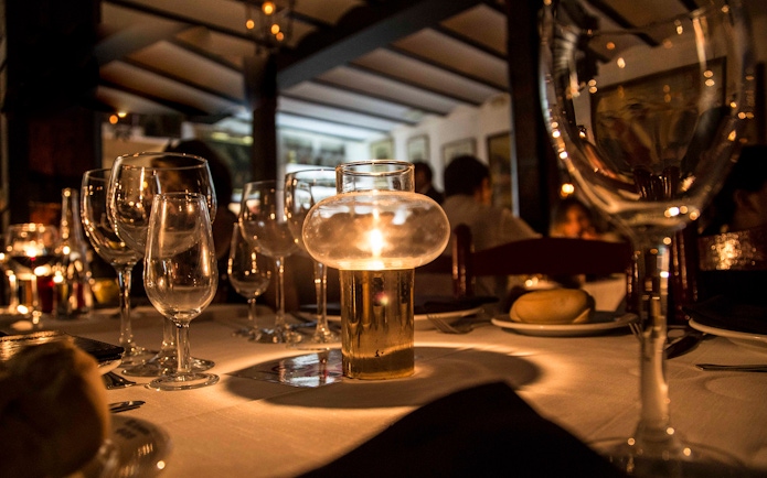 Candlelit table setting at Tablao El Arenal during a flamenco show in Seville.