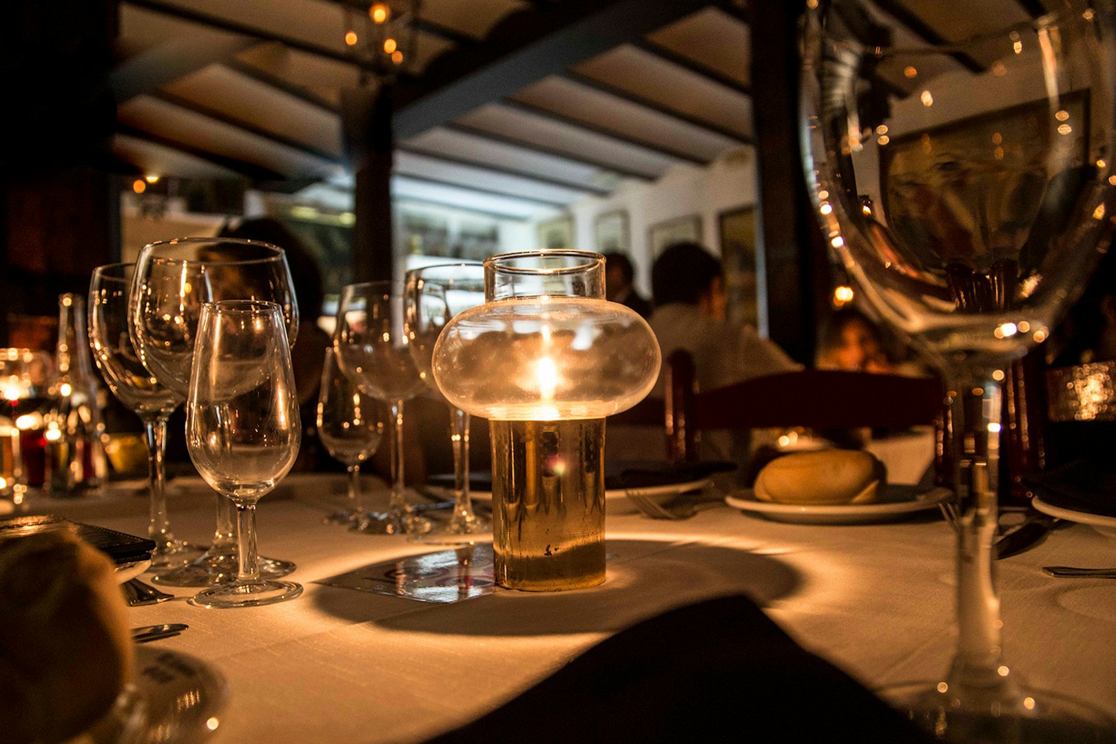 Candlelit table setting at Tablao El Arenal during a flamenco show in Seville.
