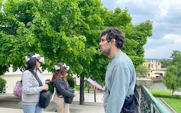 Tour guide leading a virtual reality experience in Prague.