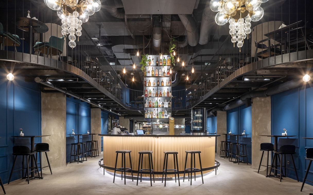 Bar area setup for Czech tapas cuisine tasting tour with seating and bottle display.