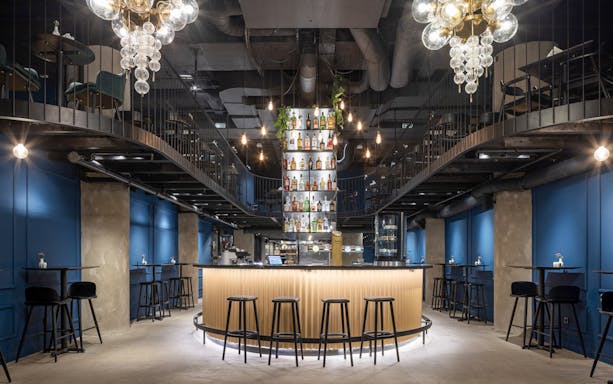 Bar area setup for Czech tapas cuisine tasting tour with seating and bottle display.