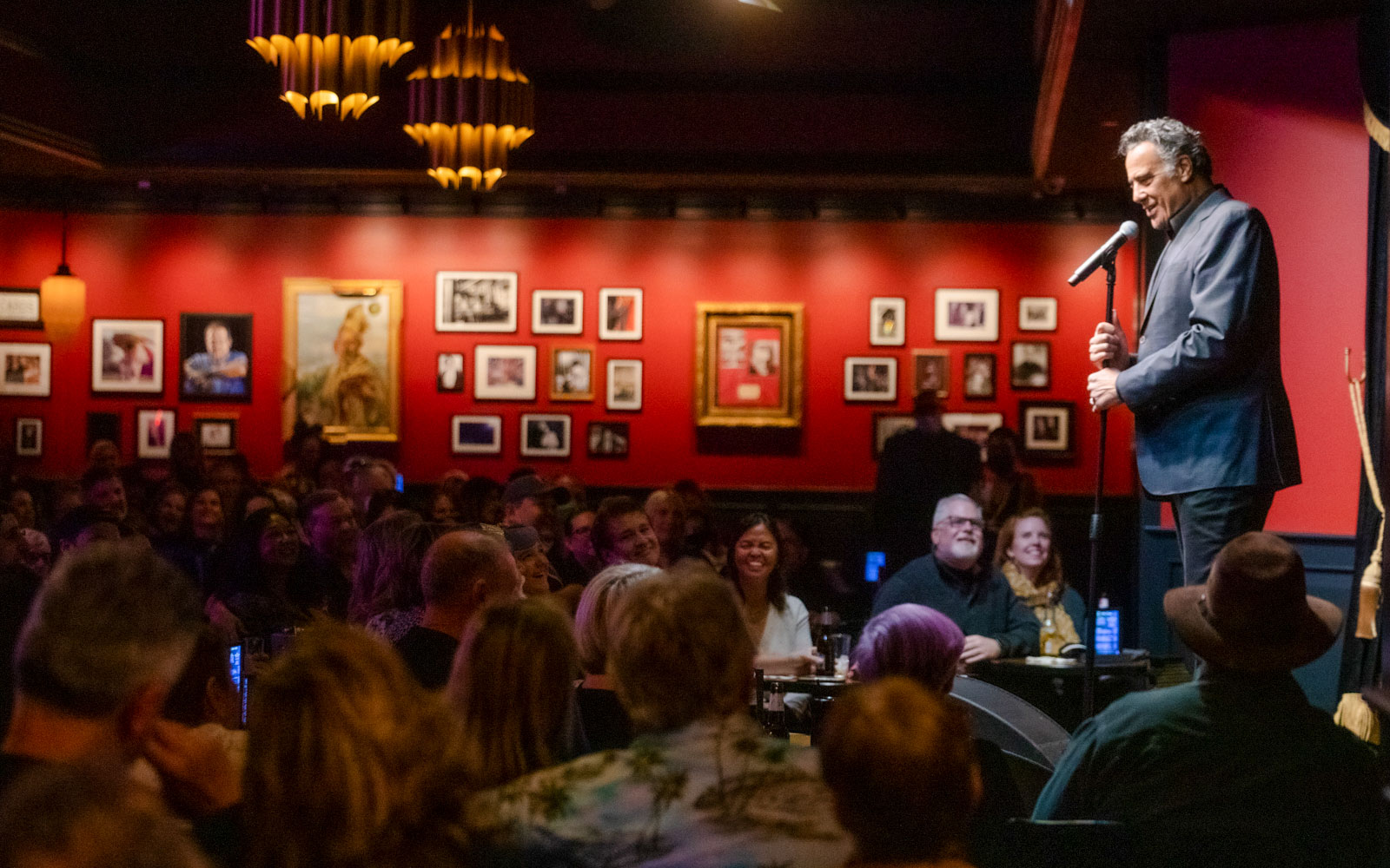 Comedian performing on stage at Brad Garrett's Comedy Club in Las Vegas.